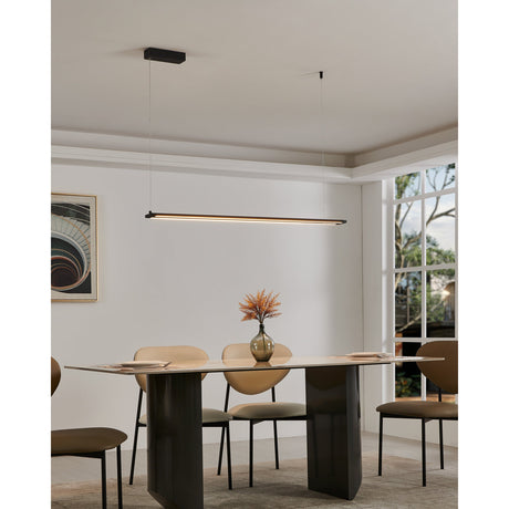 Amontillado Pendant Light in Black, a slim 116cm LED bar suspended on two wires above a dining table, shown with a warm glow in a living room setting.