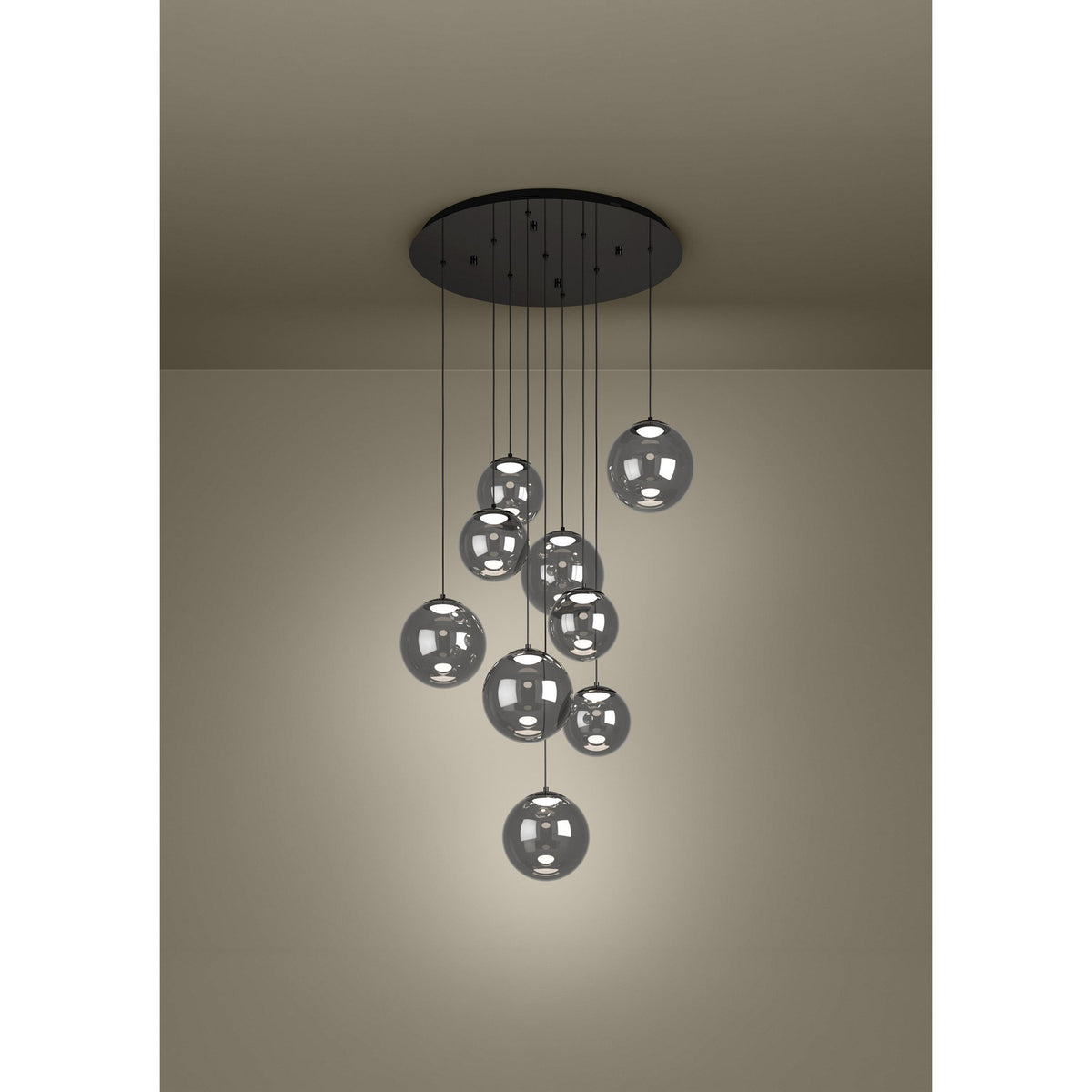 Anorias 9 Light Pendant with smoked glass globes of varying sizes cascading at different heights from a round black nickel ceiling canopy.
