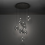 Anorias 9 Light Pendant with smoked glass globes in varying sizes, suspended at different heights from a round black nickel ceiling canopy, shown against a grey background.