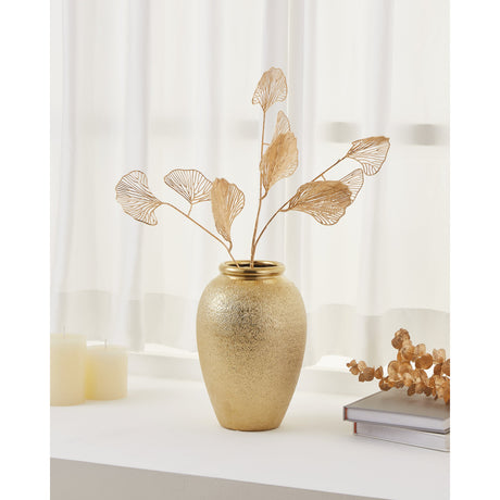 Aramberri Ceramic Vase 25cm in gold with a textured ovoid body and glossy rolled rim, holding gold wire leaf stems on a windowsill beside candles and a book.