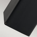 Close-up of an elegant black geometric object, much like the Arendal 1 Light Medium Bollard - Black, displaying a sharp angle and a small screw in one corner, set against a light gray background. Its design reflects chic outdoor lighting styles with coastal lighting influences.