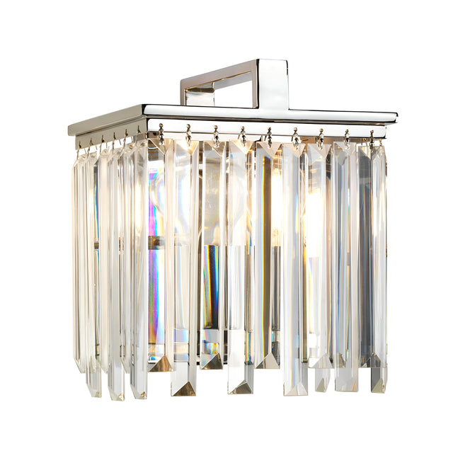 The Aries Wall Light - Polished Nickel showcases a square chrome base embellished with hanging cut glass crystals, producing a shimmering effect as light filters through them. Its refined design is highlighted by polished nickel, bringing a touch of sophistication to any space.