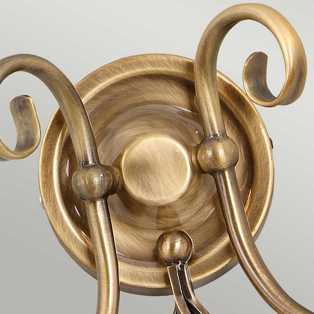 Close-up of the Artisan 2 Light Wall Light in aged brass, showcasing its curved arms and rounded base with a brushed metal finish. The design features smooth, elegant detailing in a classic style, set against a neutral background to highlight its exquisite artisan craftsmanship.