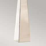 A close-up of the base of this tall, rectangular structure highlights its polished nickel finish and smooth surfaces against a neutral gray background. This striking design element shares the sleek aesthetic of contemporary pieces such as the Ascent Table Lamp With Black Shade - Polished Nickel.