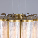 Close-up of the Ashford Acrylic 20 Light Chandelier showing scalloped clear ribbed cylinders with gold-toned metal rims and exposed wiring at the canopy, against a plain grey background.