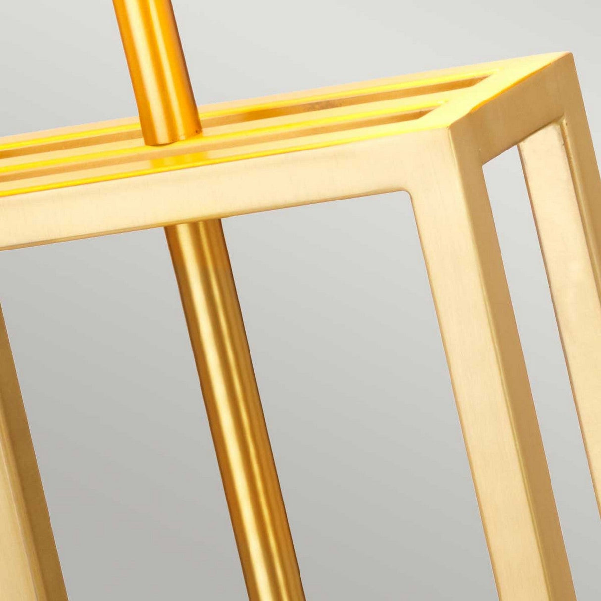 Close-up of the Atlas Table Lamp - Brushed Brass, showcasing its modern geometric design with square and rectangular shapes. The sleek structure is emphasized by the brushed brass finish, while the plain background highlights the elegance of its metallic sheen atop a sophisticated marble base.