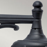 A close-up of the Bologna Outdoor 1 Light Down Wall Light in black showcases its classic design. The image highlights the top portion, featuring the finial and decorative arm, set against a light gray background. With an IP54 rating, it promises durability in diverse weather conditions.