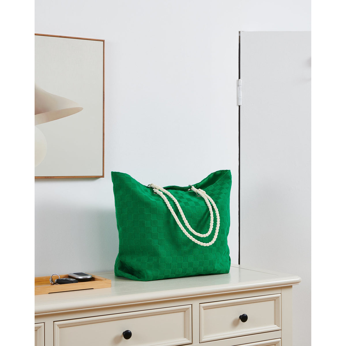 Bachuma Bag 56 x 18cm tote in green checkerboard-woven fabric with cream braided rope handles, shown on a dresser in a room setting.