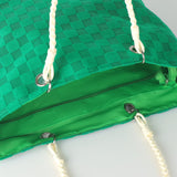 Bachuma Bag 56 x 18cm in green, close-up of the woven checkerboard exterior and bright green lining with zip pocket, metal eyelets, and cream braided rope handles.
