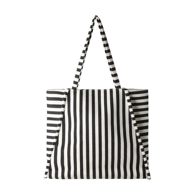 Bachuma Striped Bag in black and cream woven fabric, with vertical front stripes, horizontal side panels, two shoulder straps, and a snap-top closure, shown on a plain white background.