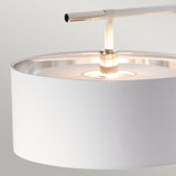 Close-up of the Balance Floor Lamp - White/Polished Nickel, showcasing its sleek metallic arm and white cylindrical shade. The gentle illumination casts a warm ambiance against a neutral backdrop, embodying the elegance of this polished nickel floor lamp.