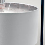 Close-up of the Balance Table Lamp - Black/Polished Nickel, featuring a white fabric shade. The interior showcases a reflective polished nickel finish, while a black vertical support pole on the right adds to its minimalist, contemporary design.