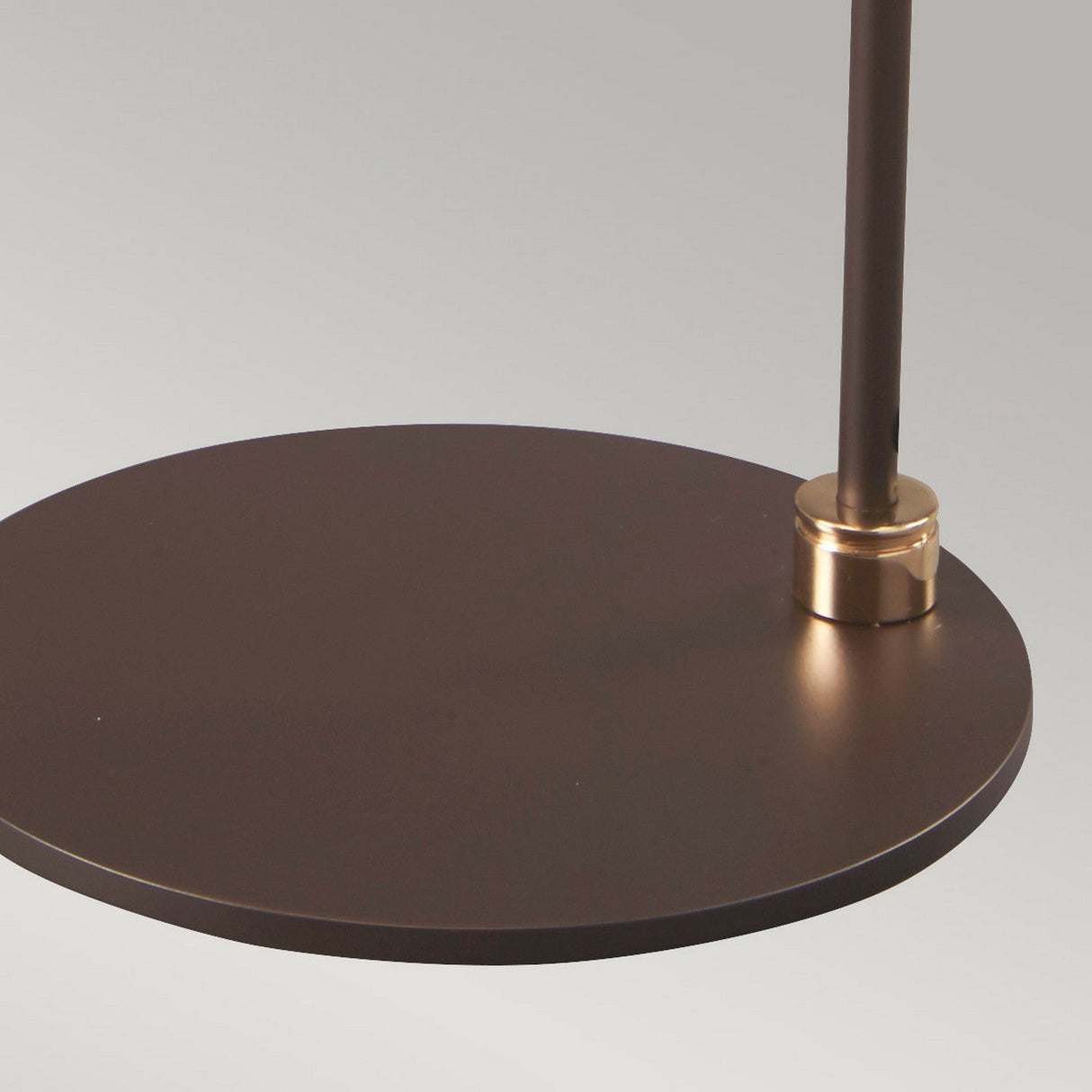Close-up of the Balance Table Lamp in brown with a polished brass accent, featuring a modern round design and a slim supporting rod, set against a neutral background.