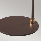 Close-up of the Balance Table Lamp in brown with a polished brass accent, featuring a modern round design and a slim supporting rod, set against a neutral background.