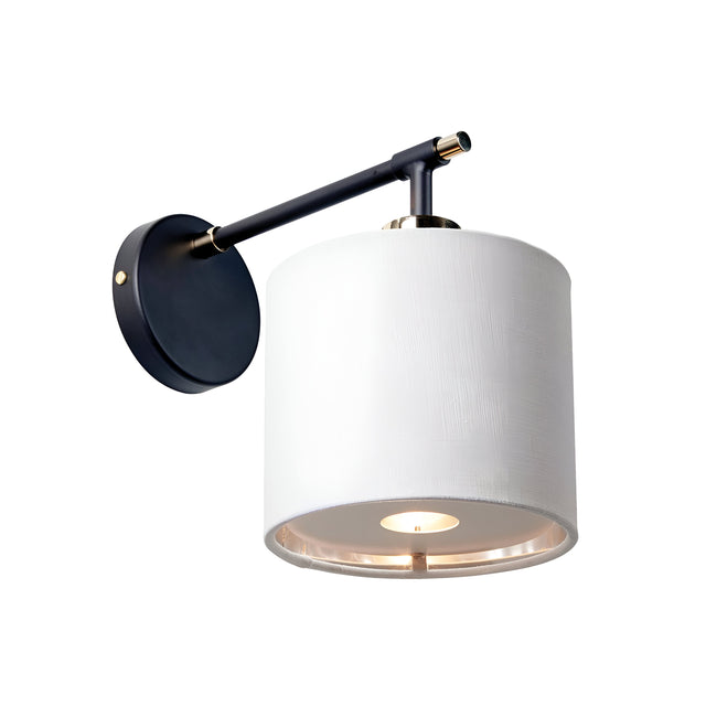 Introducing the Balance 1 Light Wall Light in Black and Polished Nickel: This contemporary wall fixture boasts a sleek black and polished nickel arm paired with a round wall mount. It features a cylindrical white fabric shade, which, when lit, projects a warm and energy-efficient glow downward.