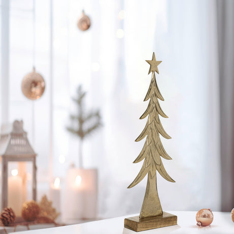 Baliguian Decorative Tree 65cm in Gold aluminium with layered leaf-shaped tiers and star top, set on a mango wood base, displayed on a table in a festive room setting.