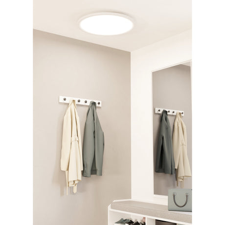 Balvena Smart LED Flush Ceiling Light 60cm in white, round and slim on a hallway ceiling, with coats hung on a wall rack and mirror below.