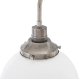 Close-up of the Bamako Glass Globe Wall Light showing the opal glass sphere beneath an antique silver finish holder and curved metal arm, on a plain white background.