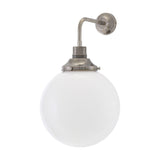 Bamako Glass Globe Wall Light - 25cm opal glass sphere on a brass holder with bent arm and round wall plate in antique silver finish, plain white background.
