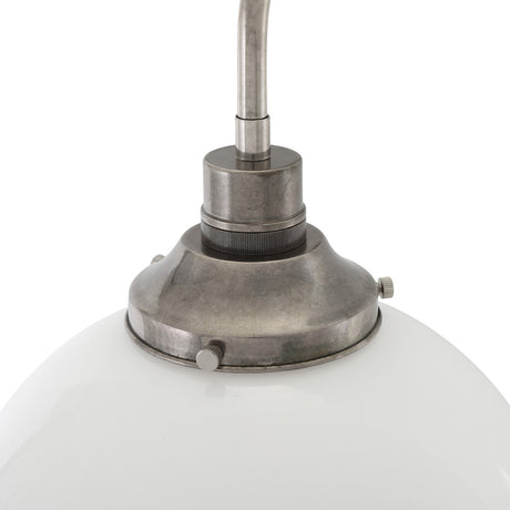 Close-up of the Bamako Glass Globe Wall Light in antique silver finish, showing the brass fitting, knurled collar, and opal glass globe against a white background.