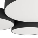 Close-up of the Barbano Smart LED flush ceiling light showing three overlapping round drums with black fabric sides and white diffuser faces on a black steel body.