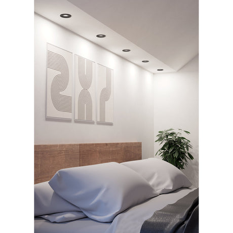 Barranco round recessed downlights in black, 9cm plastic body, fitted in a bedroom ceiling above framed line-art wall panels.