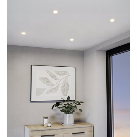 Baselle Fixed Downlight Set of 3 in white, round recessed GU10 ceiling lights with slim trims, shown installed in a hallway ceiling above a framed leaf print and sideboard.