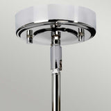 A close-up of the Agatha 1 Light Pendant - Polished Chrome showcases its sleek, modern design. Featuring a round base and a glossy finish, this ceiling light fixture effortlessly reflects light on its smooth surface, making it ideal for bathroom lighting against a neutral light grey background.