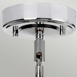 This image showcases the Agatha 3 Light Pendant in polished chrome, featuring a sleek and modern design. The pendant has a circular base that attaches to the ceiling and a central rod extending downwards, ideal for adding a light bulb or shade.