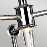 Close-up of the Agatha 3 Light Pendant - Polished Chrome, a masterpiece of modern design. It features sleek polished chrome arms and a central cylindrical bulb holder with a vertical light tube. The minimalist design is reflective, set against a plain background, capturing elegance effortlessly.