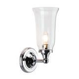 The Austen-2 Wall Light - Polished Chrome is a wall-mounted fixture that features a clear glass shade and an exposed LED G9 bulb. Its sleek design includes a circular base and curved arm, adding a modern touch to any interior decor.