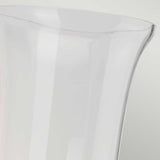 A close-up image showcases the rim of a clear, tall glass vase set against a light gray background, subtly reflecting the sheen of an Austen-2 Wall Light - Polished Chrome. The vase features a smooth, curved edge and appears to be empty.