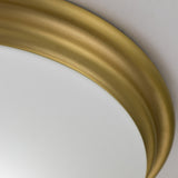 Close-up of the Brompton Flush Light with a thick, brushed brass frame highlighting a plain, white surface. The design of the light features a smooth, slightly curved Art Deco style, adding a touch of elegance to any room.