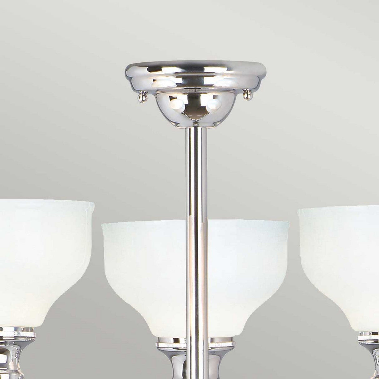 A close-up of the Cheadle 3 Light Semi Flush - Polished Chrome, featuring a sleek design with opal glass shades and three curved lamp fixtures. The polished chrome ceiling mount is clearly visible against a neutral gray background.