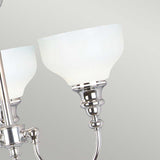 Close-up of the Cheadle 3 Light Semi Flush in polished chrome, featuring opal glass shades against a plain light background. The design showcases smooth curves and a reflective finish, combining elegance with simplicity.