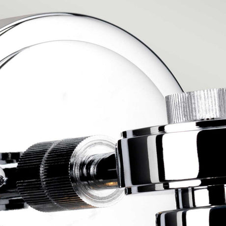 Close-up of the Gunnislake 1 Light Wall Light with its sleek, cylindrical design and polished chrome finish. The image showcases the smooth texture and intricate construction of this metallic wall light against a neutral background.