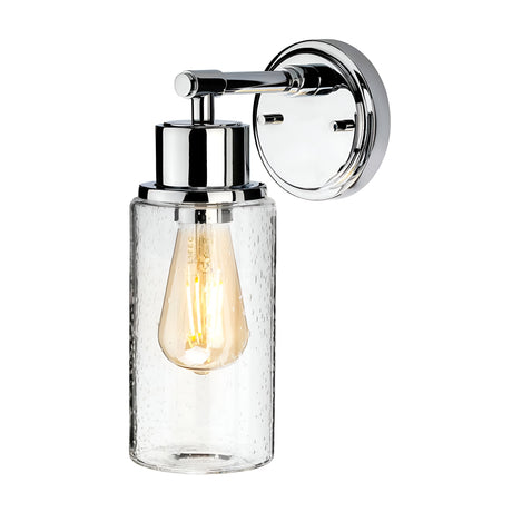 The Morvah 1 Light Outdoor Wall Light in Polished Chrome is a wall-mounted fixture designed for outdoor use. It showcases a clear glass shade and an exposed vintage-style Edison bulb, all elegantly mounted on a circular backplate with a sleek metallic finish.