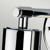 A close-up of the modern Morvah 1 Light Outdoor Wall Light showcases its cylindrical base and horizontal arm. Its polished chrome finish elegantly reflects light against a neutral background, perfectly suited for both indoor and outdoor environments.