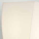 Close-up of the Shirebrook 1 Light Wall Light in polished chrome, featuring a minimalistic, off-white lampshade with soft lighting. Its smooth surface and chrome accents offer a clean and contemporary appearance, while the IP44 rating ensures it is suitable for damp environments like bathrooms.