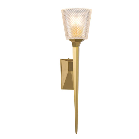 The Verity 1 Light Wall Light in brushed brass features a contemporary wall-mounted design with a cut glass shade and a sleek, elongated metallic base. Its energy-efficient LED lamp emits a warm glow, enhancing its elegant appearance.