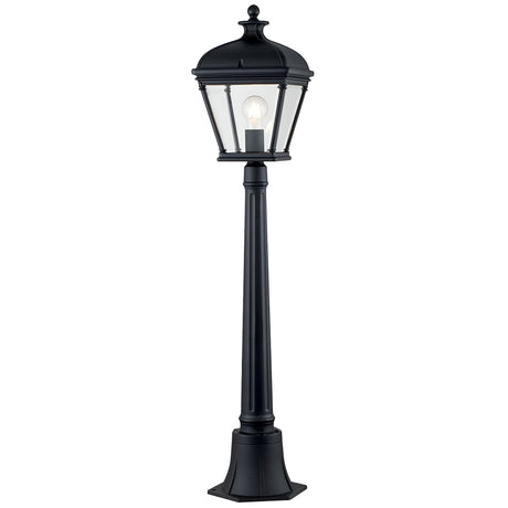 The Bayview 1 Light Medium Pillar Lantern - Black exudes Georgian-inspired elegance with its classic black lamp post and lantern-style fixture. Clear glass panels showcase the bulb within, while the post stands securely on a square base, adding timeless outdoor lighting charm to any garden or patio.