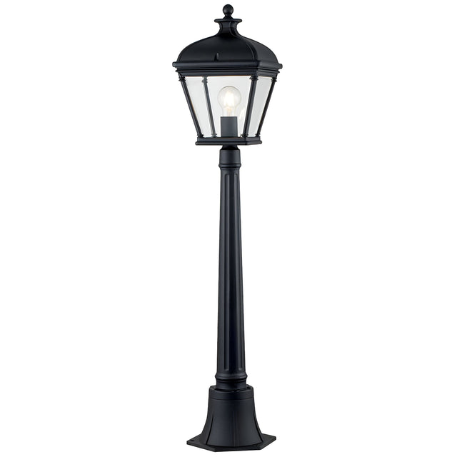The Bayview 1 Light Medium Pillar Lantern - Black exudes Georgian-inspired elegance with its classic black lamp post and lantern-style fixture. Clear glass panels showcase the bulb within, while the post stands securely on a square base, adding timeless outdoor lighting charm to any garden or patio.