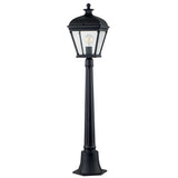 The Bayview 1 Light Medium Pillar Lantern - Black exudes elegance with its Georgian-inspired design, featuring a clear glass lantern and visible bulb that evoke a sense of timeless charm. Set against a plain white background, this lamp post captures the sophistication of classic outdoor lighting.