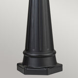 A timeless Bayview 1 Light Lamp Post in black, featuring a fluted cylindrical design and a wide hexagonal base, stands against a gray background, reminiscent of classic outdoor lighting styles.