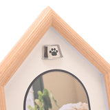 Close-up of the Dog House Plastic Photo Frame in brown wood-grain effect, showing the silver paw print emblem above the white arched mount.