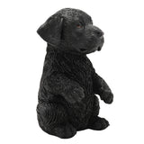Sitting Up Labrador Puppy Resin Figurine, 16cm, in black with floppy ears and raised front paws, textured coat detail, shown on a plain white background.