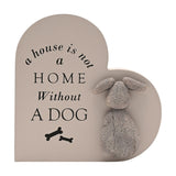 Grey MDF heart-shaped wall plaque with "A House Is Not A Home Without A Dog" in black lettering, two bone icons, and a raised textured grey dog figure, on a white background.