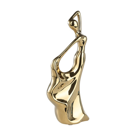 Benangin Ceramic Figurine in Gold, an abstract female form with one arm looped overhead and a flowing, wave-like draped base, high-shine finish, plain background.