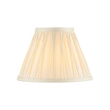 Bevdon 20cm tapered lamp shade in ivory silk with pinch-pleat detailing and cream trim, shown against a plain white background.