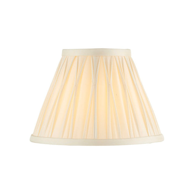 Bevdon 20cm tapered lamp shade in ivory silk with pinch-pleat detailing and cream trim, shown against a plain white background.